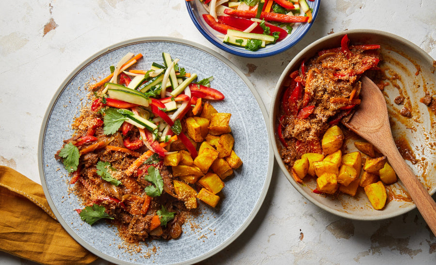 Indonesian beef rendang with turmeric potatoes and zucchini, carrot and capsicum salad