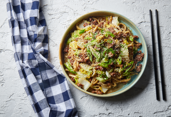 Ginger and soy beef udon noodles with wombok and sesame in a bowl