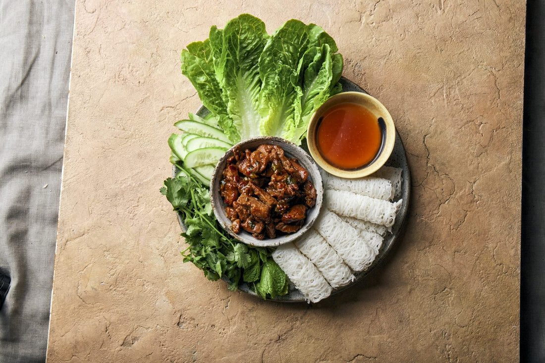 Sizzling beef banh hoi platter with nuoc cham, fresh herbs and lettuce