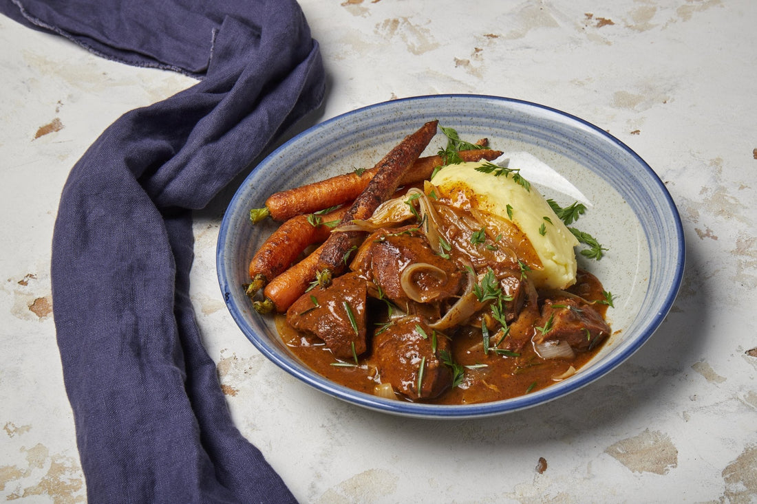 Slow cooked beef in red wine sauce with mashed potato and carrots