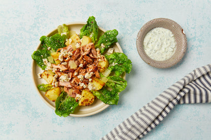 Plated meal with fresh greens and a creamy dipping sauce from an Atlas Market meal kit