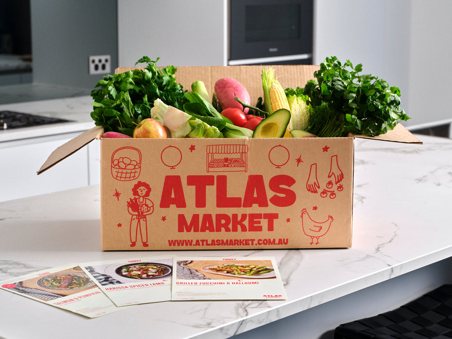 Atlas Market Cuisine Box with fresh vegetables and recipe cards